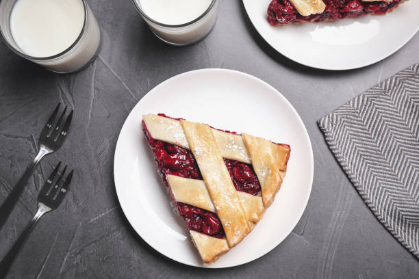 Slice of delicious fresh cherry pie served on grey table, flat lay Slice of delicious fresh cherry pie served on grey table, flat lay crostata stock pictures, royalty-free photos & images