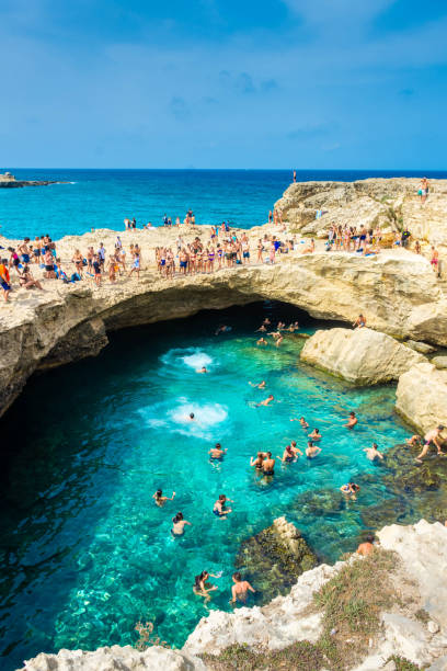 Apulia SALENTO, ITALY, 11 AUGUST 2021: People diving in the crystal clear water of the Grotta della Poesia (Poetry Cave) puglia beach stock pictures, royalty-free photos & images