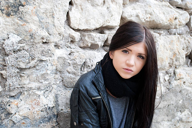 istock Beautiful model in front of stone wall 135625114