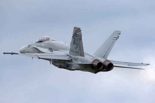 Swiss Air Force McDonnell Douglas F/A-18C multirole fighter aircraft departing Payerne Airport. Payerne, Switzerland - August 31, 2014: Swiss Air Force McDonnell Douglas F/A-18C Hornet multirole fighter aircraft departing Payerne Airport. fa 18 hornet stock pictures, royalty-free photos & images