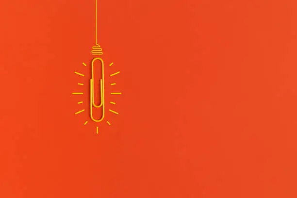 Light bulb on red background. Inspiration and creative idea concept. Top view with copy space. Flat lay composition.