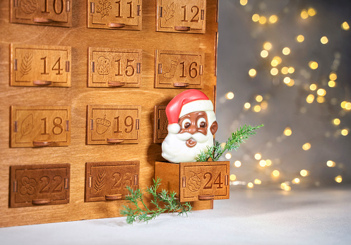 Wooden christmas advent calendar with chocolate santa claus