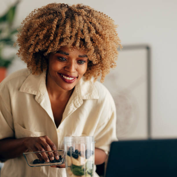 istock Smiling Woman Making Healthy Breakfast in the Kitchen 1356258288