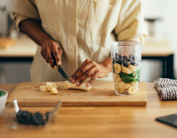 Close Up of Woman Hands Cutting Banana on a Cutting Board