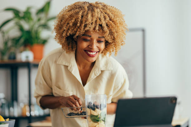 istock Smiling Woman Making Healthy Breakfast in the Kitchen 1356258294