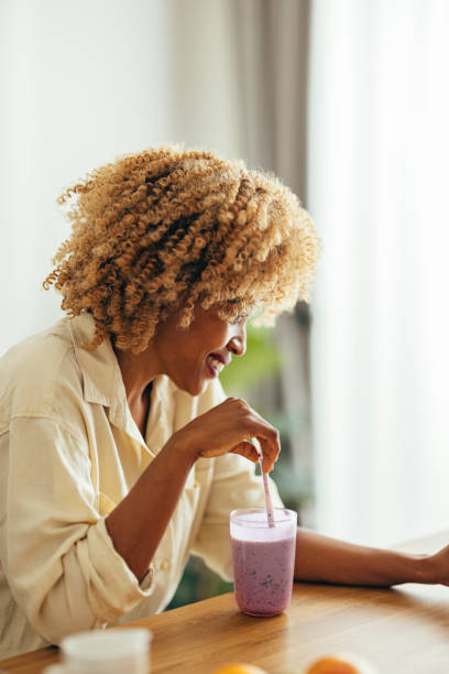 istock Smiling Woman Having Healthy Breakfast at Home 1356258309