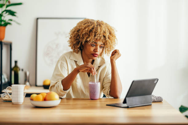 istock Serious Woman Using Digital Tablet at Home 1356258311