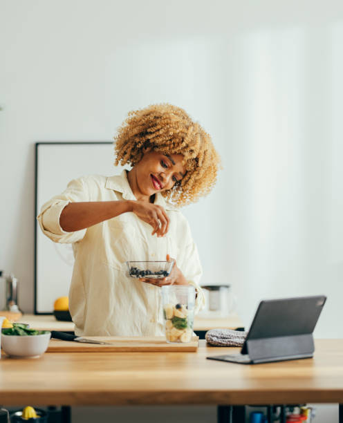 istock Smiling Woman Making Healthy Breakfast in the Kitchen 1356258388