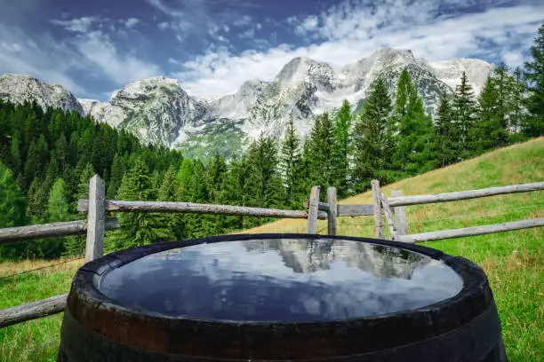 Scenic view of Totes Gebirge mountainrange with reflections on water in a barrel. Shot taken in Stodertal Vallery in the Upper Austrian Limestone Alps in summer.