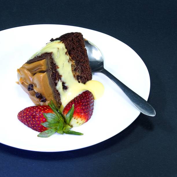 istock Chocolate Cake portion with Strawberries on a Plate. Isolated on 1356260894