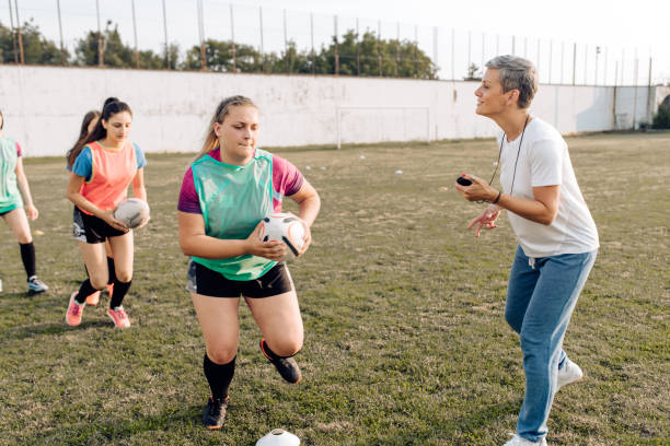 istock Woman coaching female rugby team 1356263109