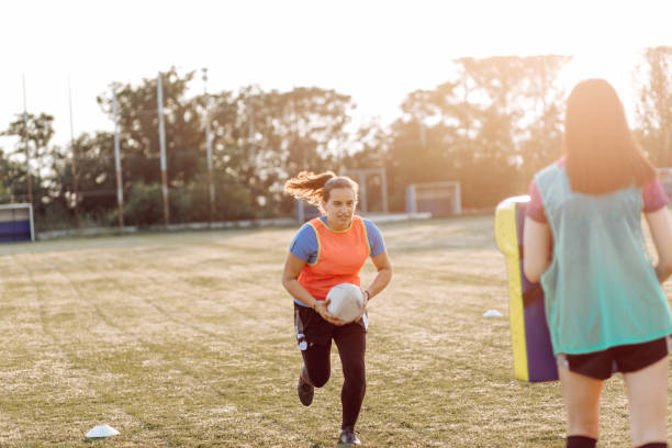 istock Girls from the university team training rugby 1356263142