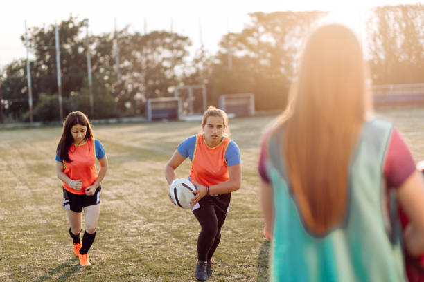 istock Girls from the university team training rugby 1356263144