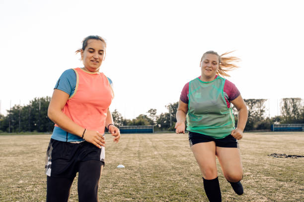 istock Female rugby team warming up for training 1356263287