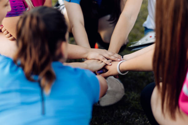 istock Female rugby team gathering and cheering 1356263330