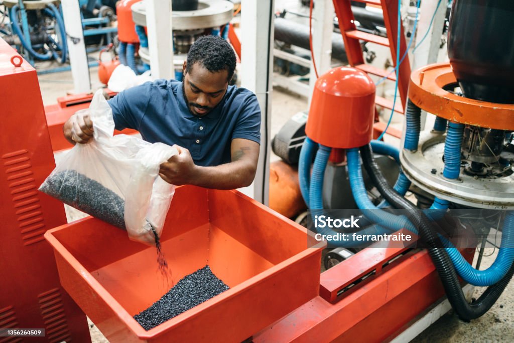 Blue collar working in plastic recycling factory Technician working in plastic recycling factory Plastic Stock Photo