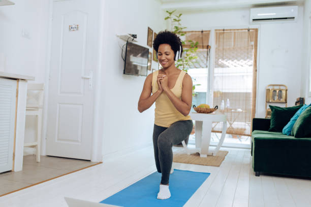 istock Afro woman on an audio-guided exercise class 1356266408