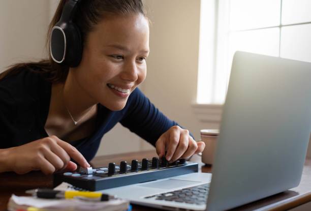 istock A woman making digital music and editing photos on computer. Work at home. 1356269314