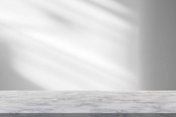 istock Marble table with window shadow drop on white wall background for mockup product display 1356271193