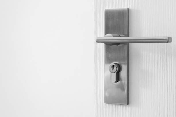 istock Modern door handle with keyhole on white door 1356272066