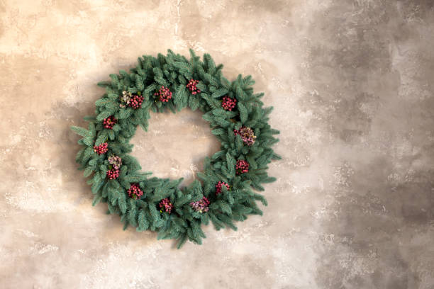 istock Christmas wreath on gray marble wall 1356272394