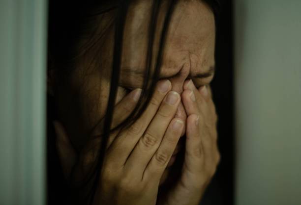 Sad woman crying alone. Victim of domestic abuse. stock photo