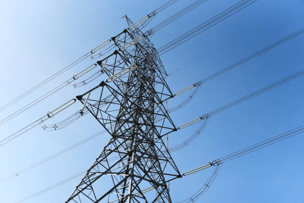 istock High voltage post, High voltage tower blue sky background, Electricity poles and electric power transmission lines against countryside 1356276958