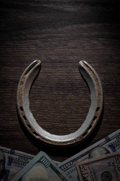 Horse shoe and cash stock photo
