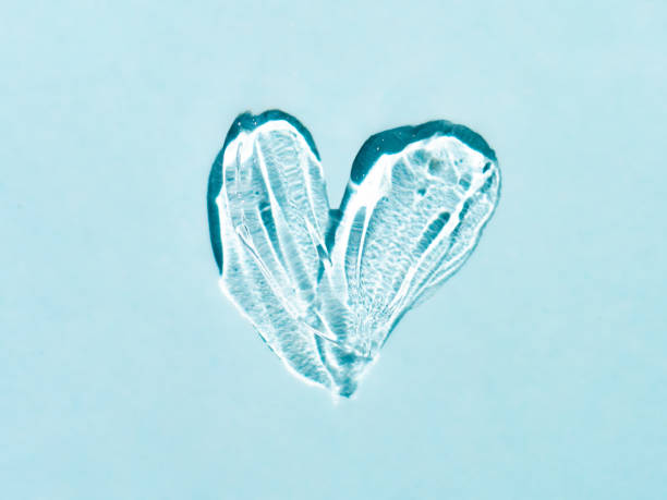 istock Transparent cosmetic gel heart shape on blue bg 1356284730