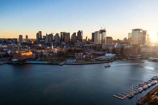 Aerial Fall photo of  downtown Boston from Boston Harbor during sunset, shot during the fall and showing sun rays