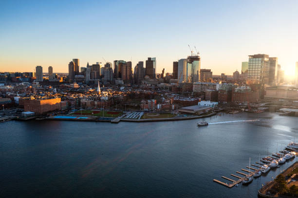 Aerial Fall photo of  downtown Boston from Boston Harbor during sunset stock photo