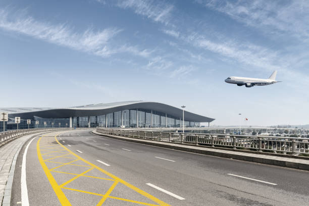 istock road and modern airport terminal 1356287393