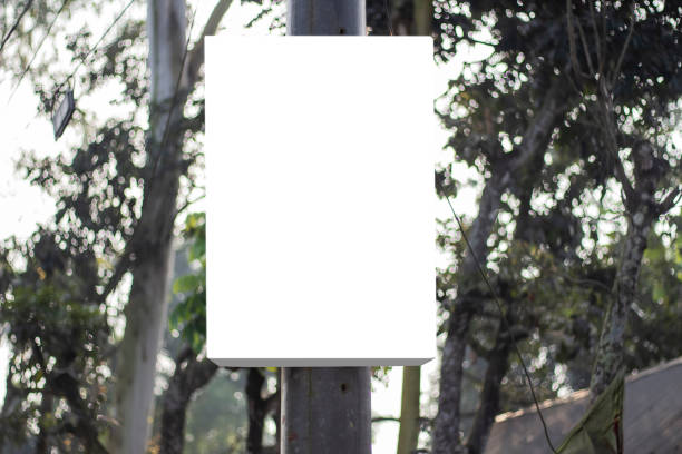 istock A large three-dimensional blank white signboard hangs from a tree in the natural environment, and the background behind it is blurred. 1356288519