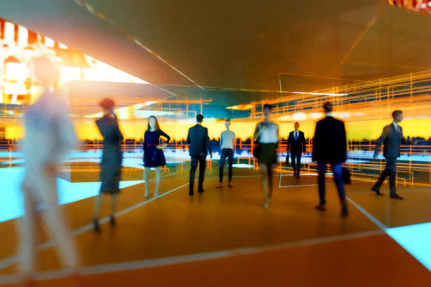 istock Abstract defocused people walking in the city at night 1356289110