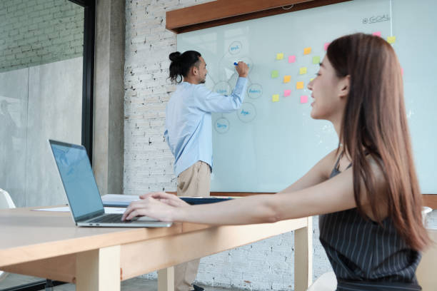 istock Two colleagues brainstorm and meeting business projects in an office. 1356291115