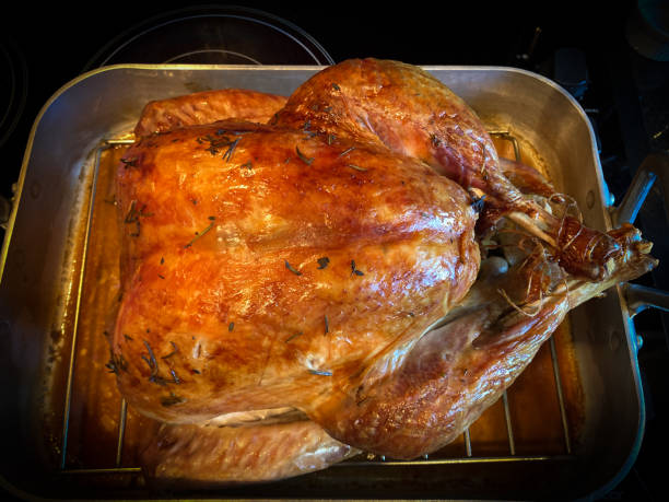 istock Beautiful Roasted Turkey in Pan on Stove Top 1356291234