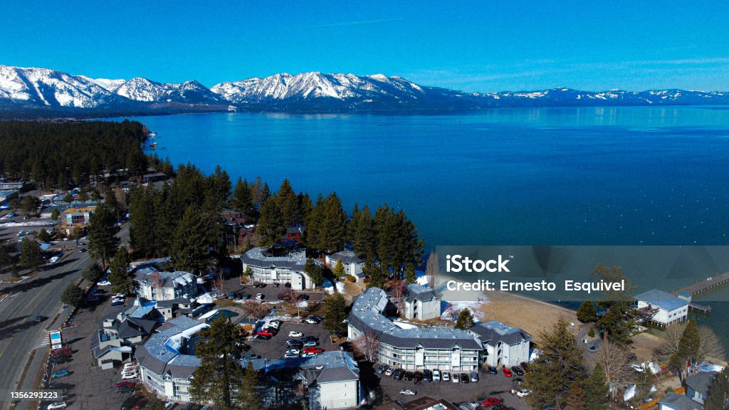 South Lake Tahoe, March 2021 Aerial view of a lake and the snowy mountains of Tahoe. South Lake Tahoe Stock Photo