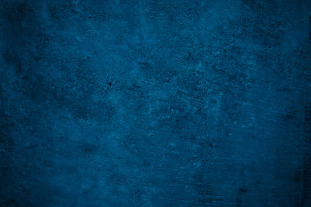 istock Navy blue rough background. Toned texture. Old scratched damaged wall surface. Blue concrete background 1356296035