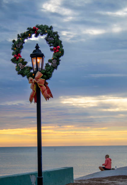 Key West FL, USA, November 29, 2021: Key West Christmas Wreath hangs on an old style light post  at the Southernmost end of island   in early morning light