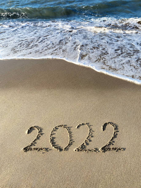 istock Happy New Year 2022 concept, lettering on the beach 1356299321