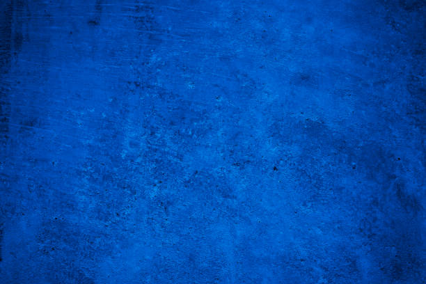 istock Navy blue rough background. Toned texture. Old scratched damaged wall surface. Blue concrete background 1356304127