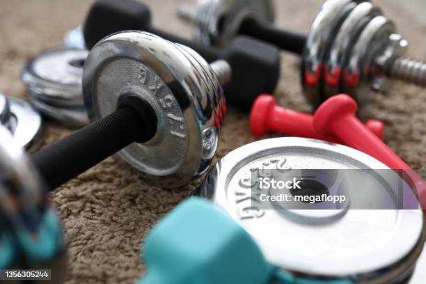 Pile Of Shiny Chrome Dumbbells Disks Lying Around Grip Stock Photo - Download Image Now