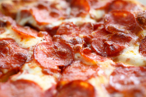 Fresh baked pizza with crusty cheese and hot tasty pepperoni ready to eat