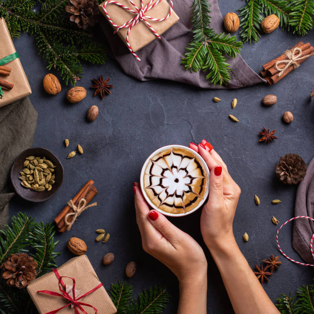 istock Christmas, female hands with gift boxes and cup of coffee 1356308256