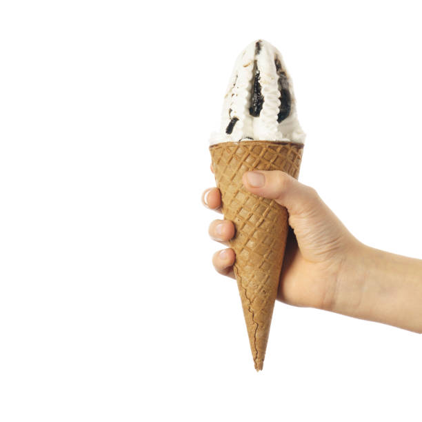 istock ice cream cone in child's hand isolated on white 1356311388