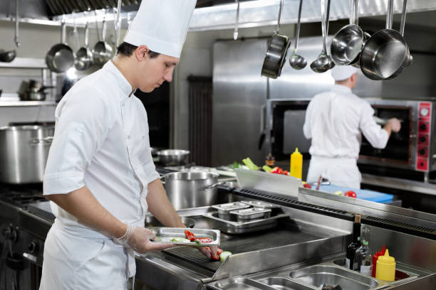istock Professional chef in the kitchen roasts vegetables on the grill 1356314673