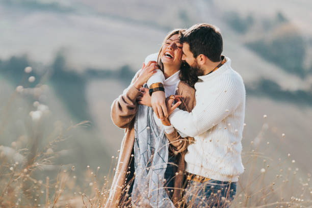 istock Happy affectionate couple embracing in autumn day in a meadow. 1356316544