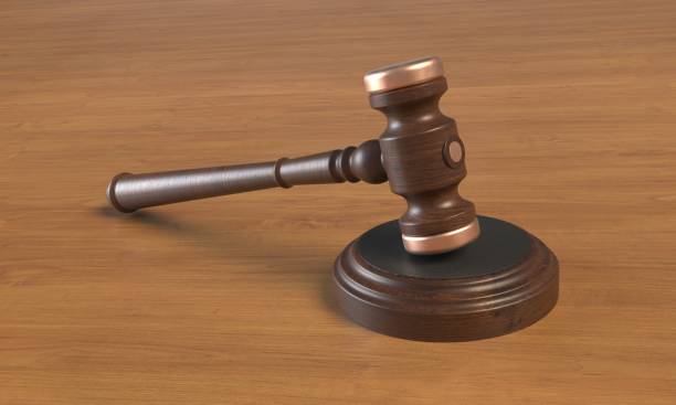 istock Wooden judges gavel on table close up. 3d rendering 1356316696