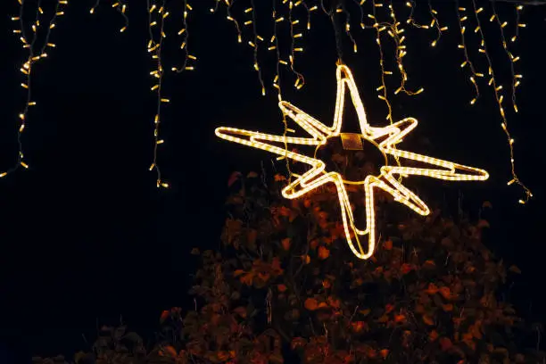 a lighted christmas star in the night