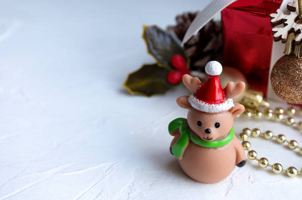 istock Cute doll and red gift box on white background. New year or Christmas decorations concept. 1356318018